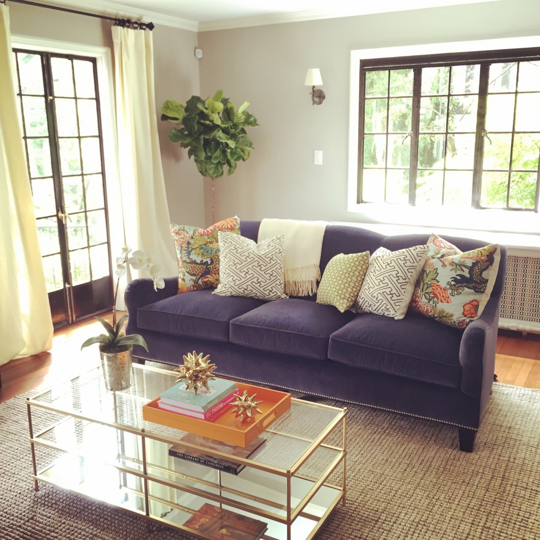 Sunny living room with a purple couch